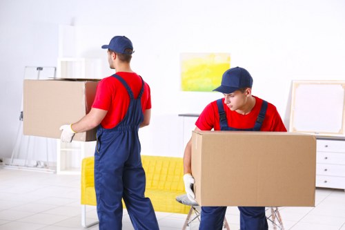 People loading boxes and furniture during a Queenspark removals service