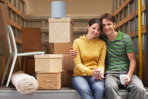 Mover wearing PPE while handling boxes in a property move