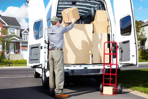 Specialist movers preparing a piano for transport in Queenspark