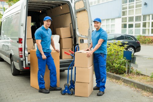 Removal team loading furniture in a busy urban street