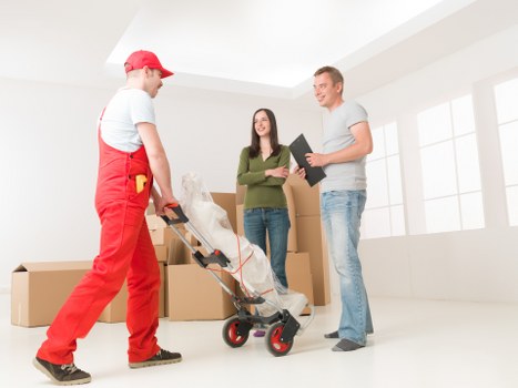 Professional movers handling furniture during a Queenspark relocation