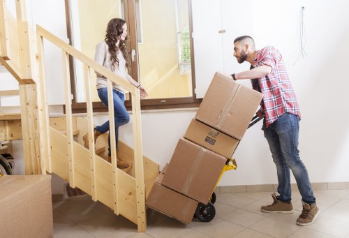 Office furniture being moved by Queenspark removal professionals